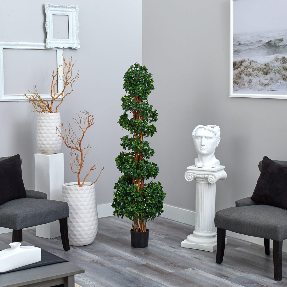 a room with a plant and statues