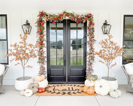a door with pumpkins and flowers