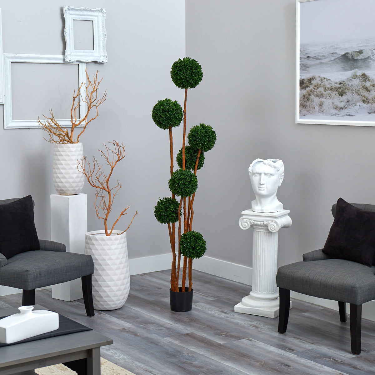 a room with a statue and a plant