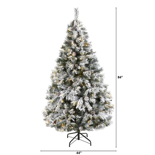 a tall christmas tree with lights and snow