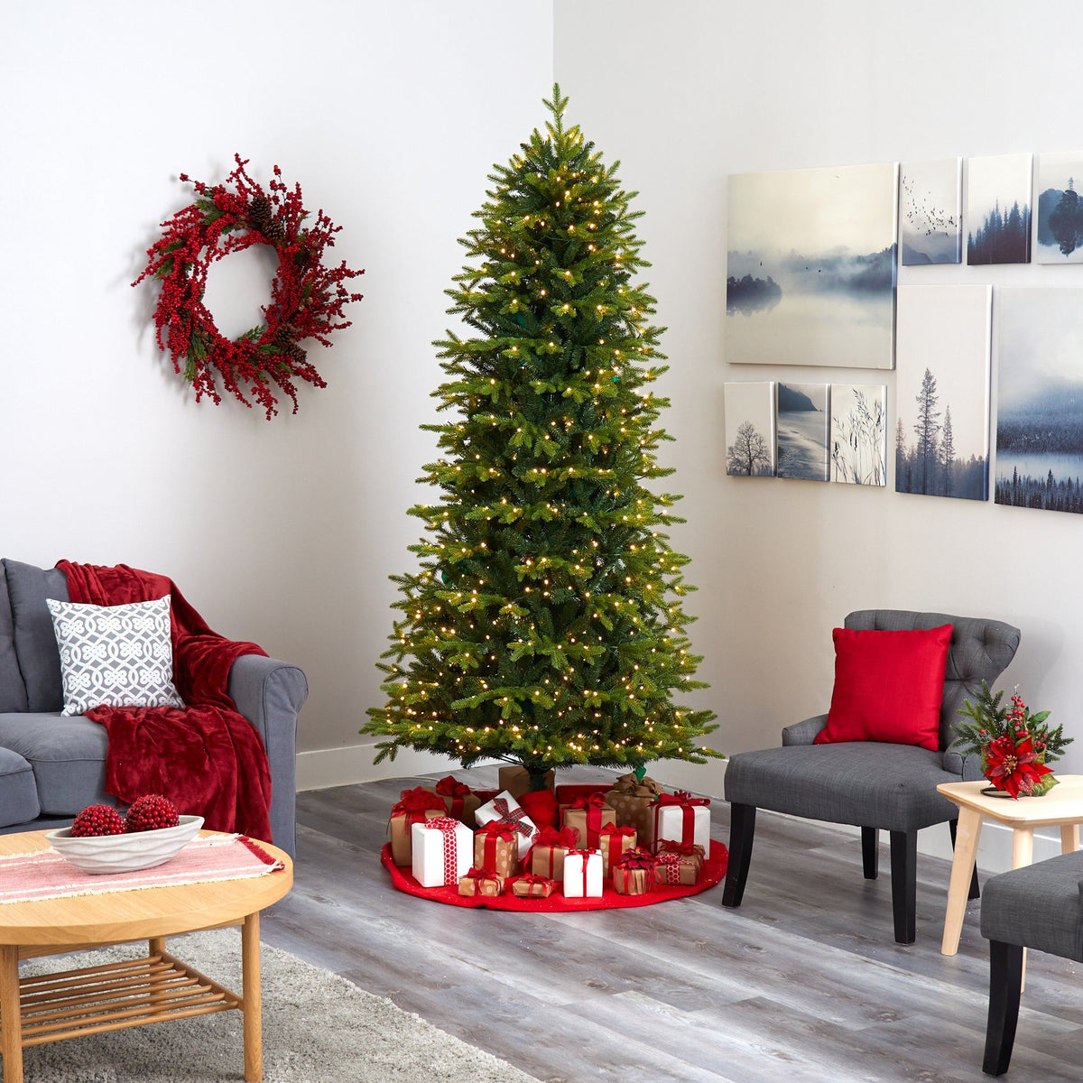 a christmas tree in a room with a couch and a wreath