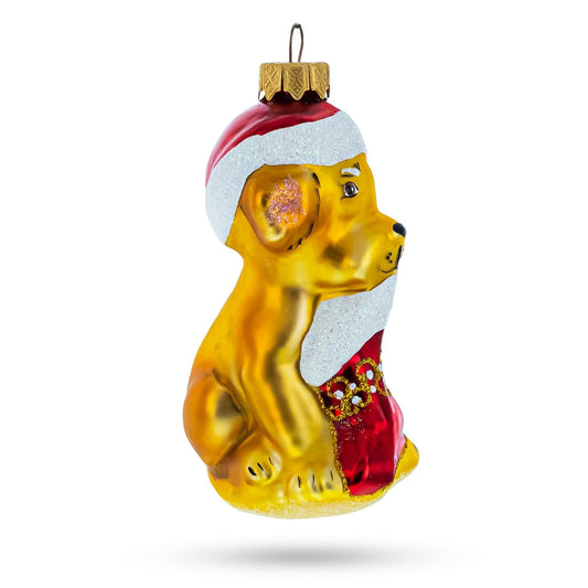 a yellow dog ornament with a red hat and white scarf