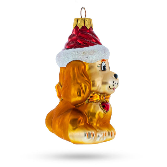 a gold dog ornament with a red hat