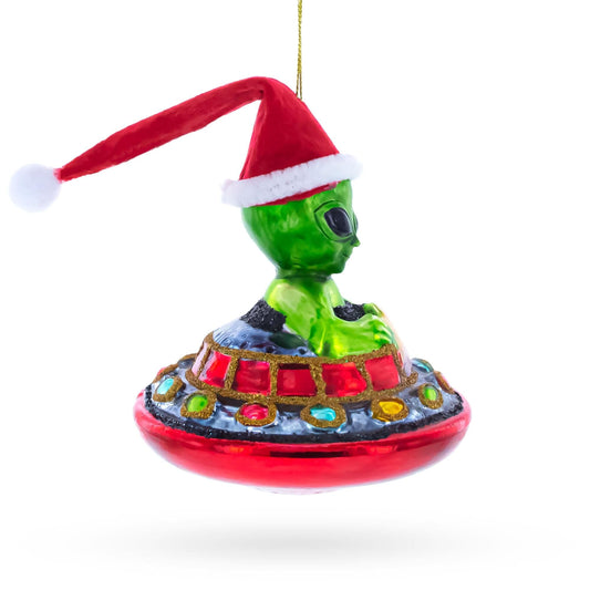 a green alien with a red hat and a red ufo
