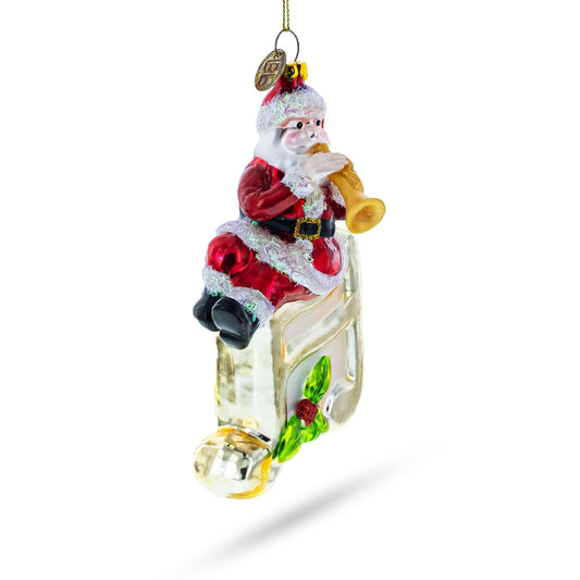a christmas ornament with santa claus playing a trumpet