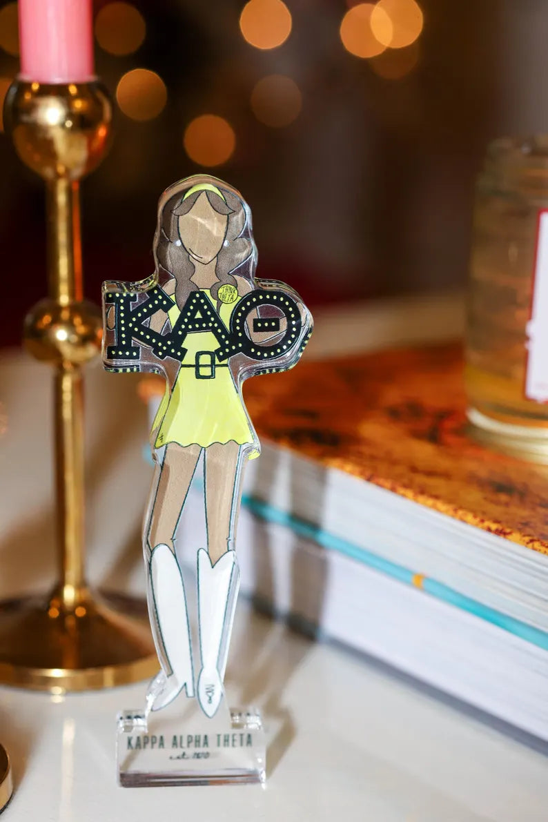 a figurine of a woman in a yellow dress