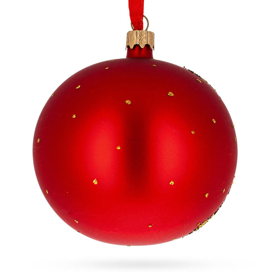 a red christmas ornament with gold specks
