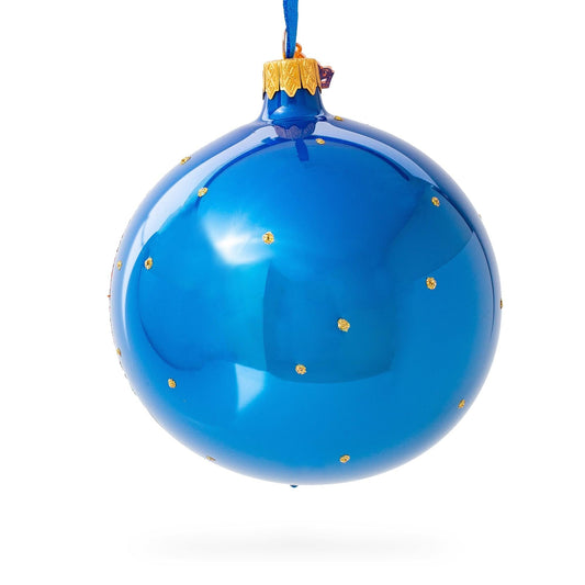 a blue christmas ornament with gold dots