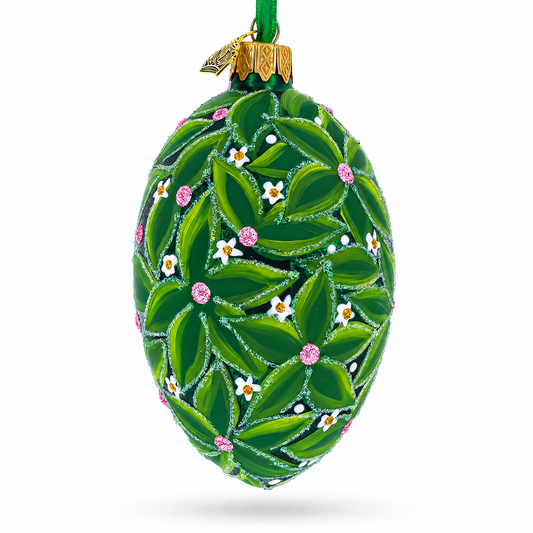 a green decorated egg with leaves and flowers