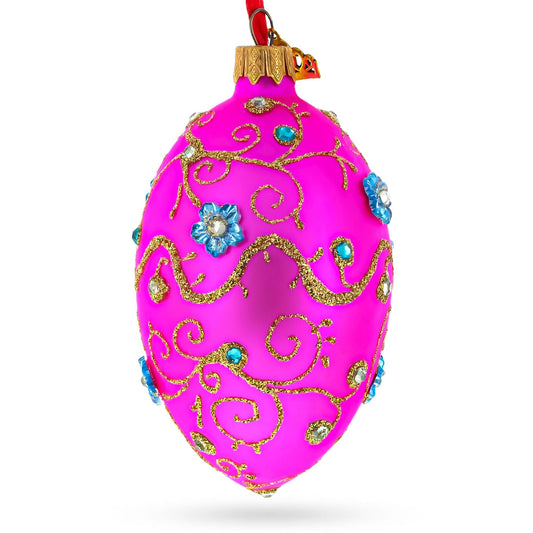 a pink ornament with gold and blue designs