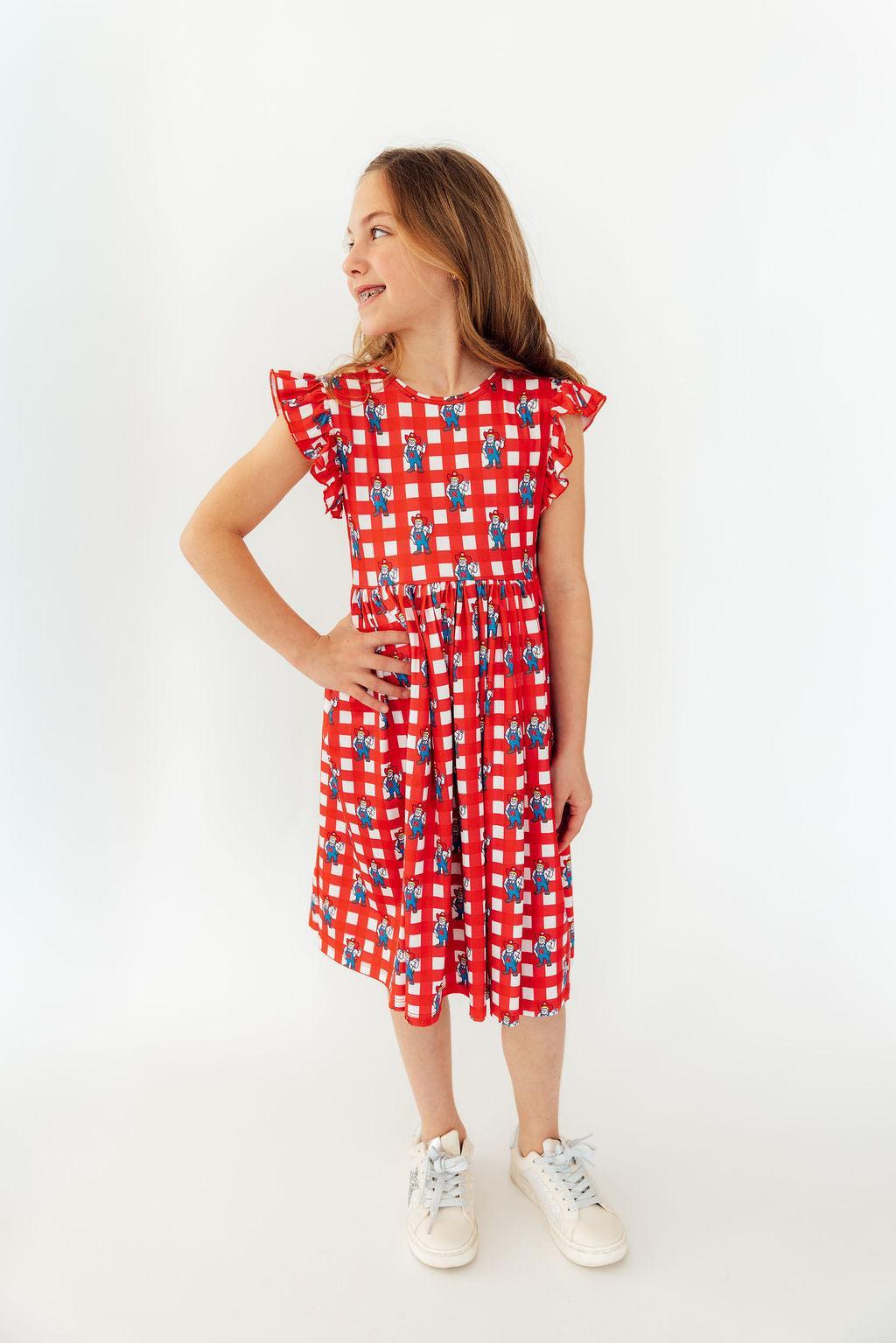 a girl in a red and white checkered dress