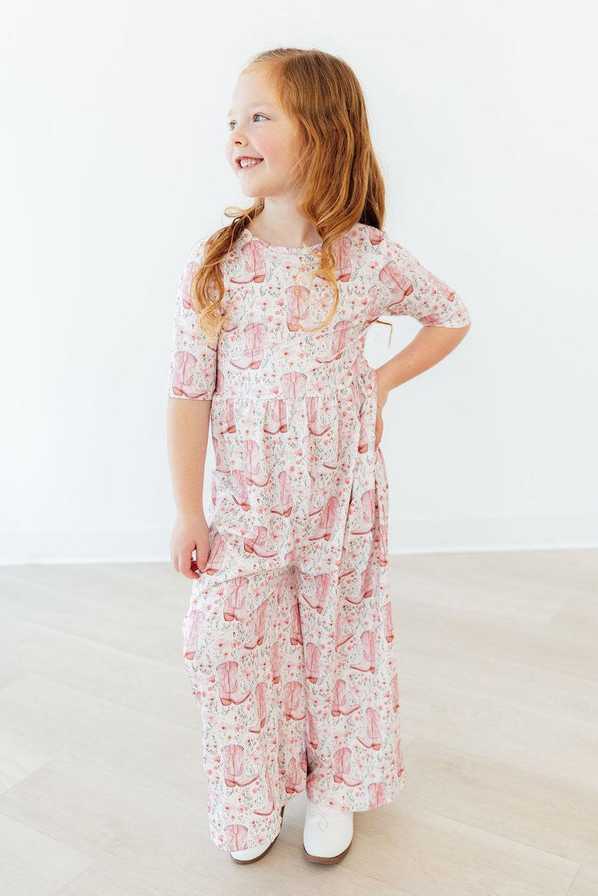 a girl in a pink and white pajamas