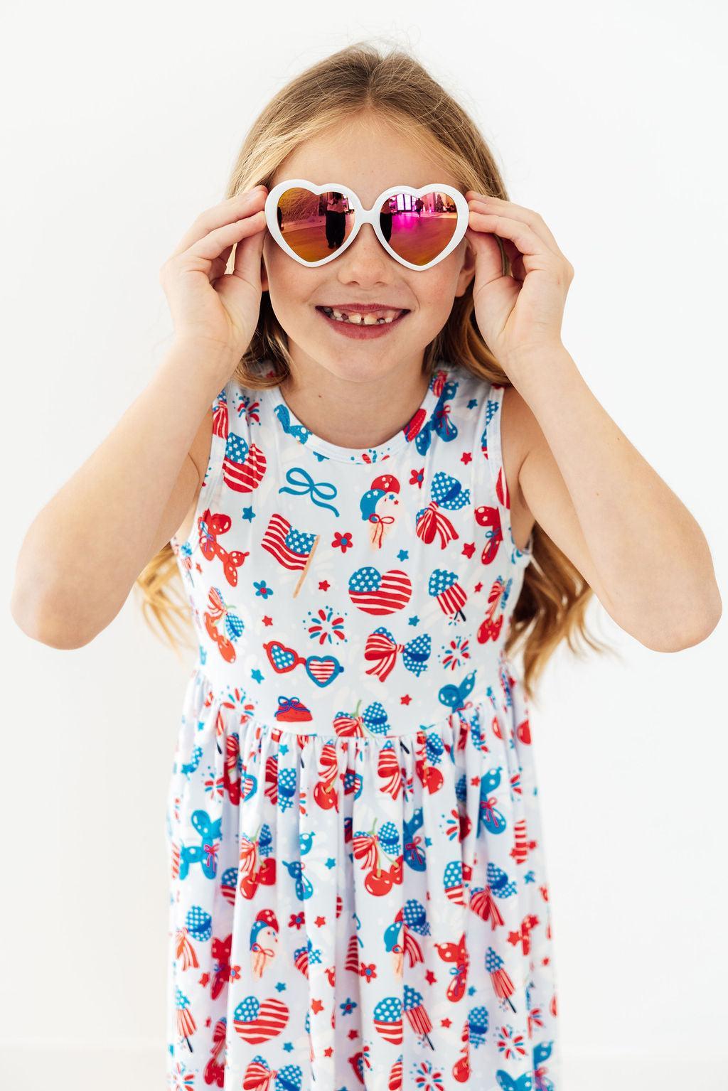 a girl wearing heart shaped sunglasses