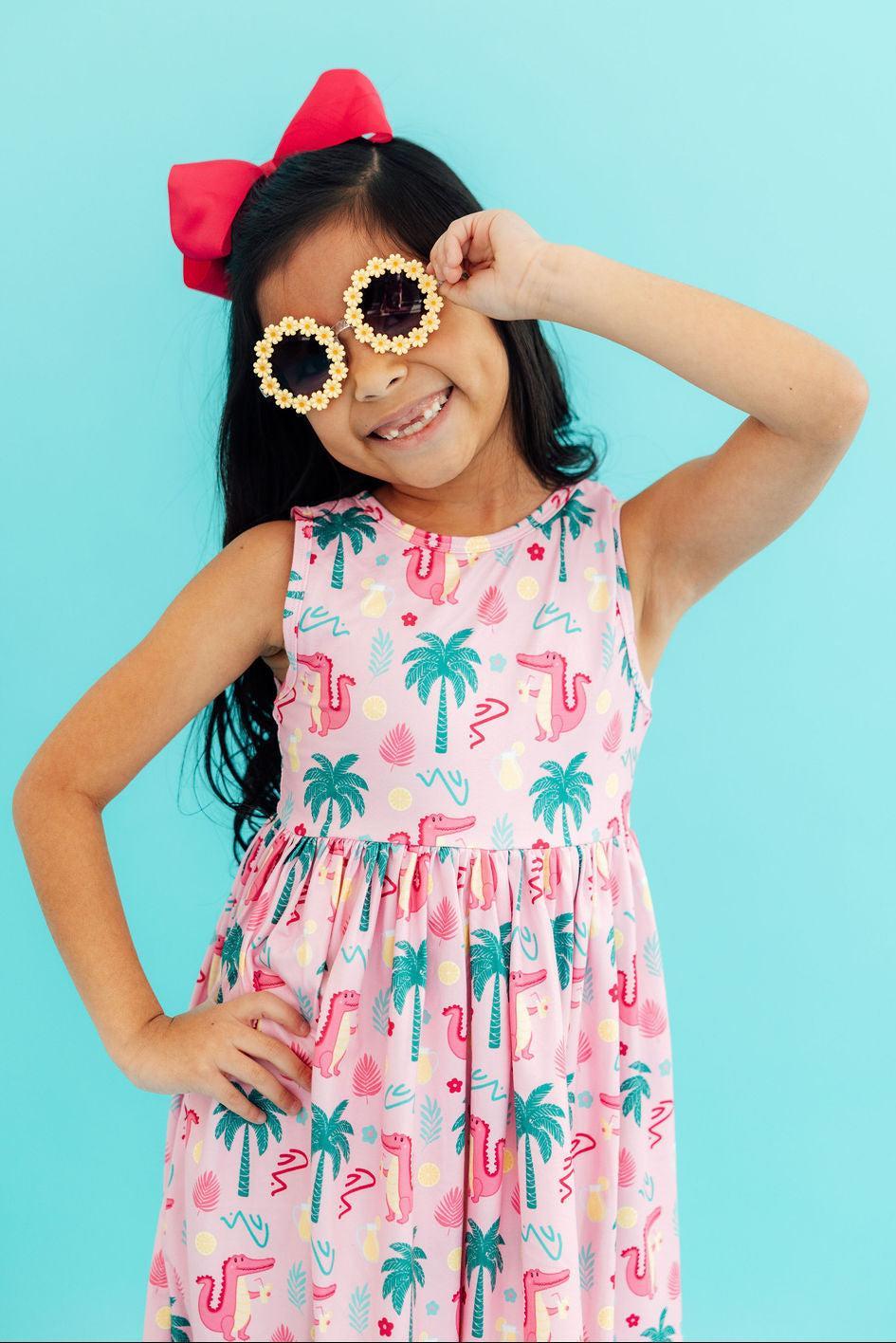 a girl wearing sunglasses with flowers on them