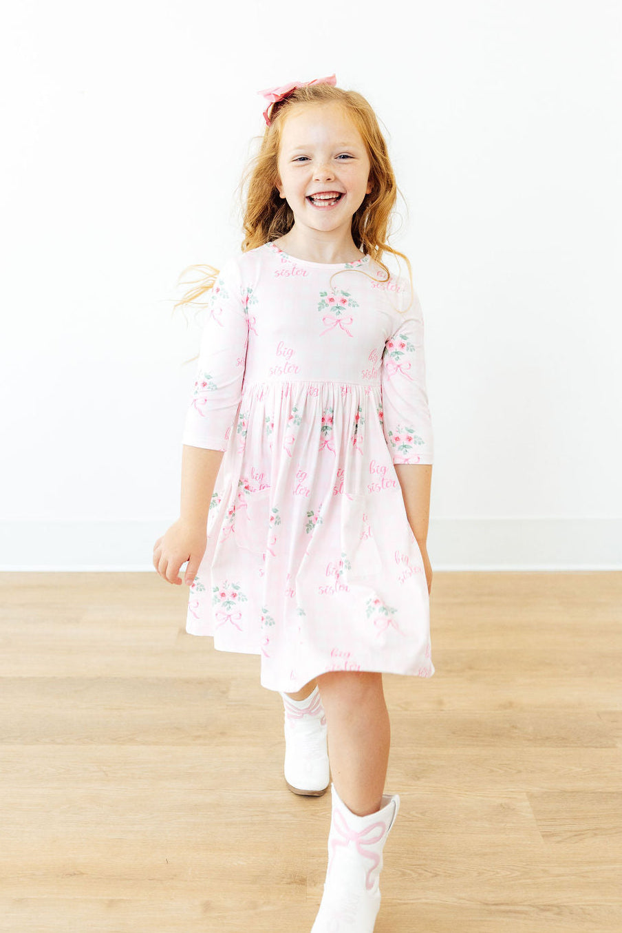 a girl in a pink dress