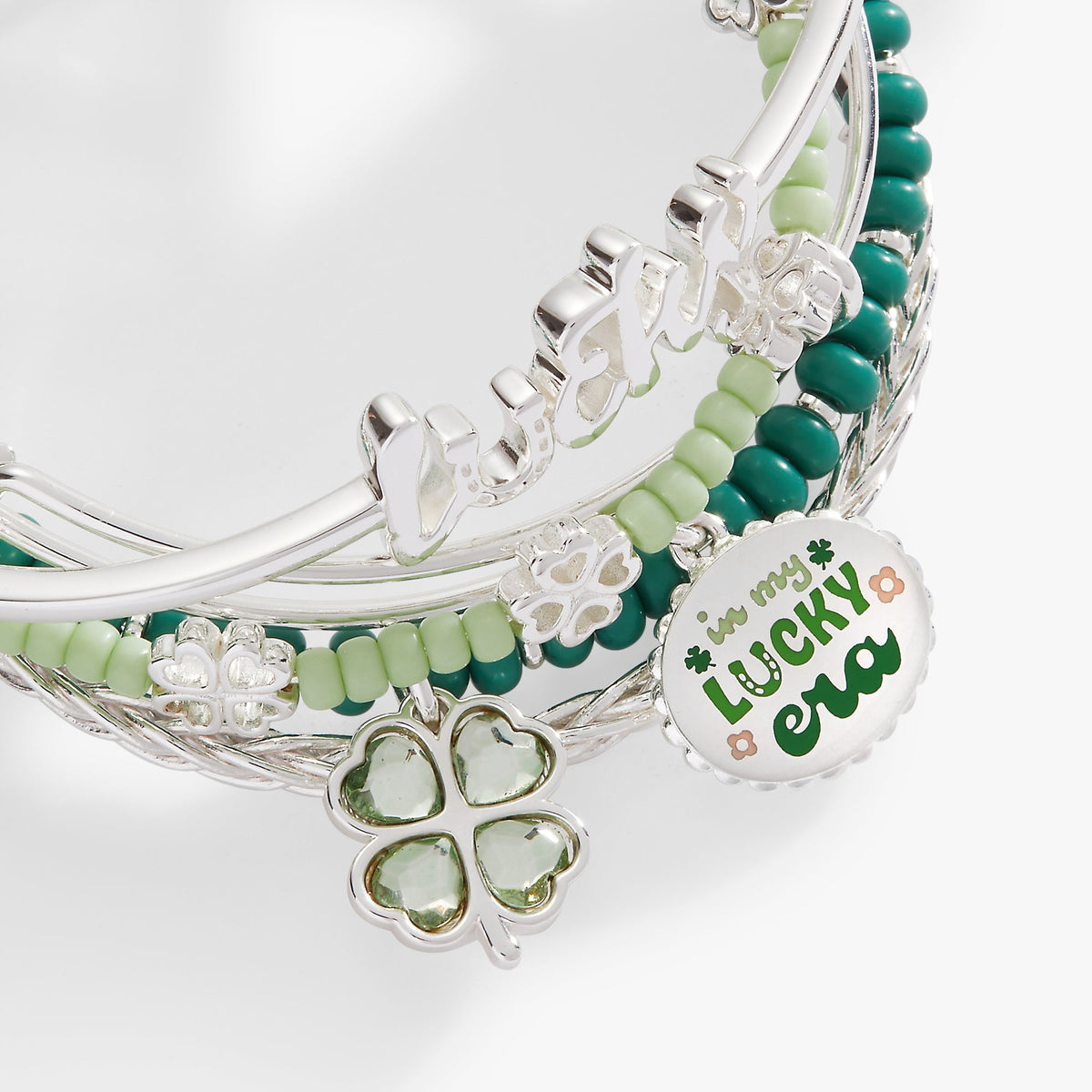 a bracelet with green and white beads
