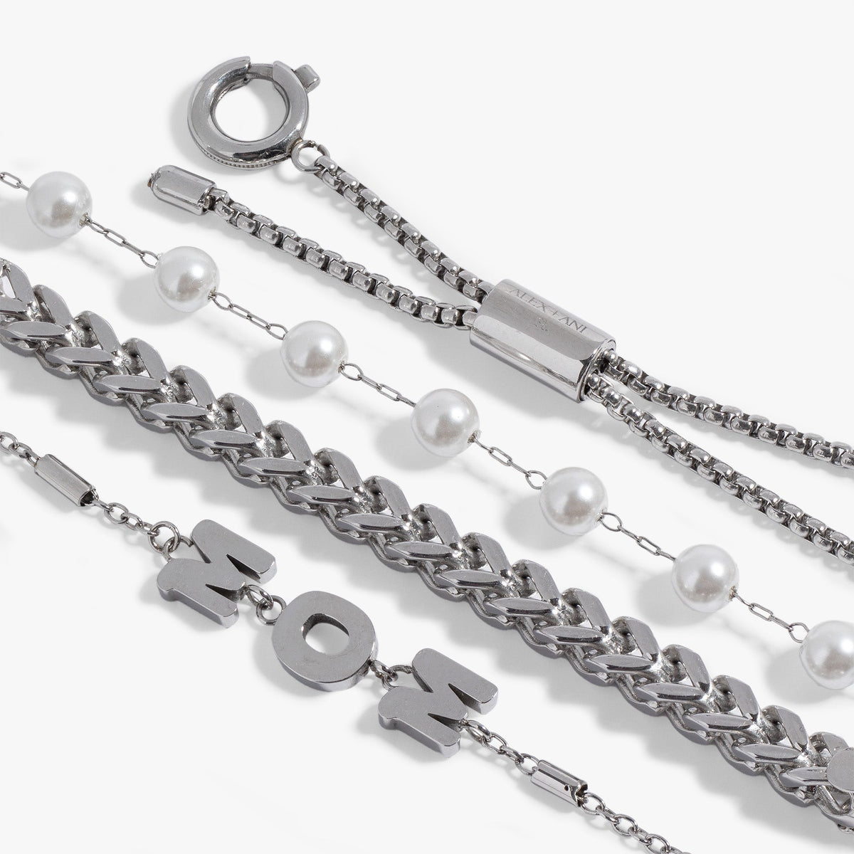 a group of silver chains with pearls