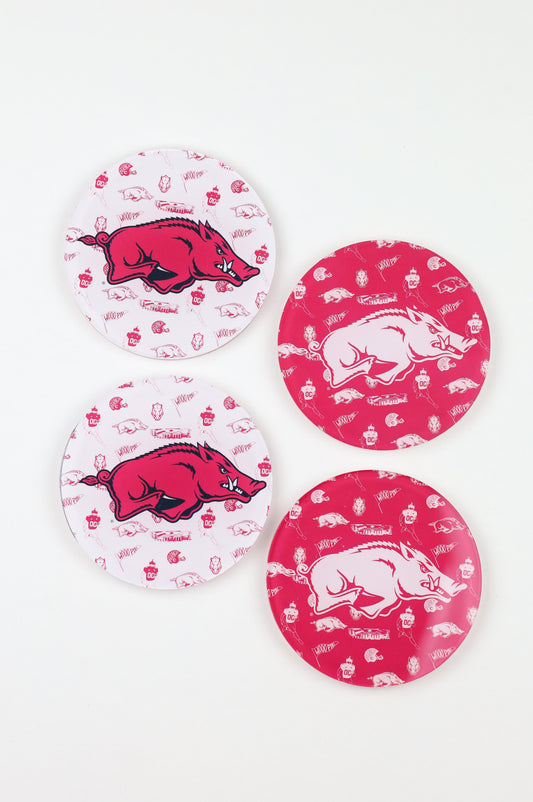 a group of round red and white plates with a pig on it