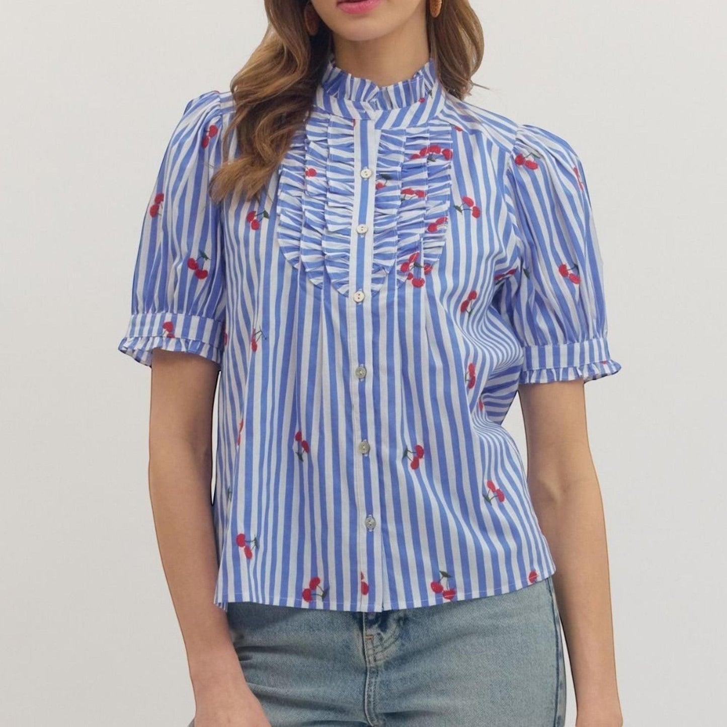 The Merry Hare blue and white striped cotton blouse with embroidered cherries, ruffle bib front, and puff short sleeves.