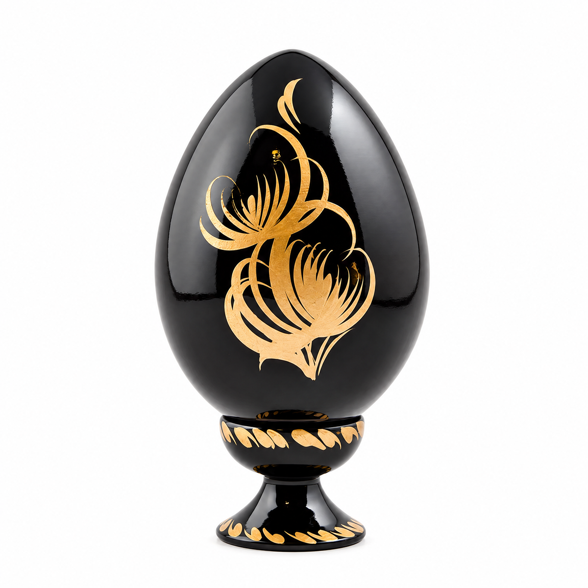 a black egg shaped object with gold designs