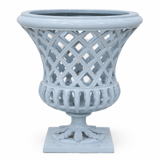 a white vase with a lattice design