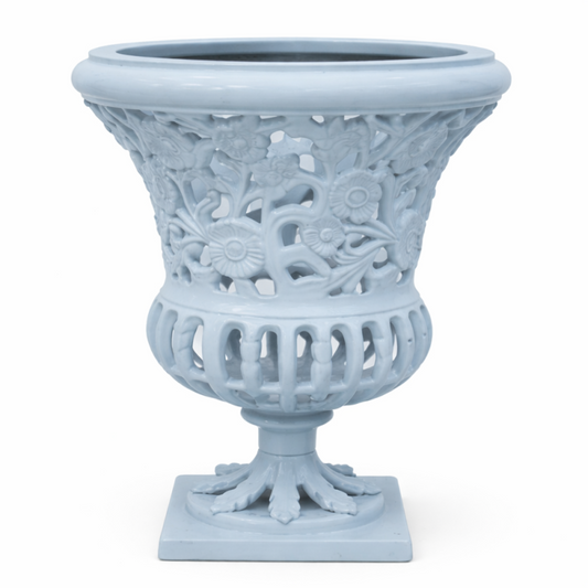 a white vase with a floral design