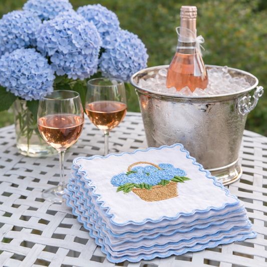 a stack of napkins and a bottle of wine on a table