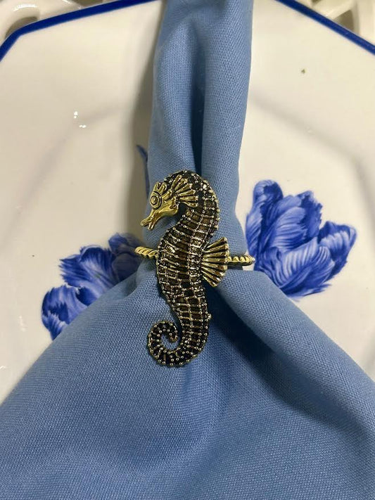 a seahorse ring on a napkin
