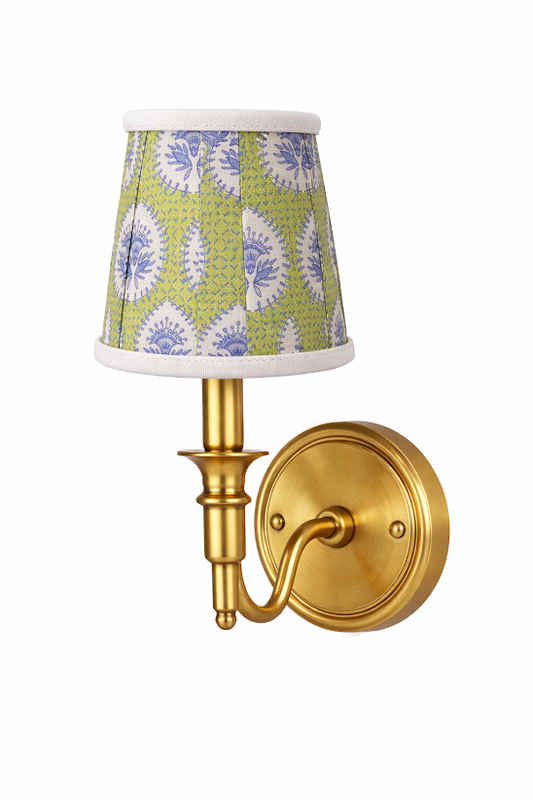 a gold wall lamp with a green and blue shade