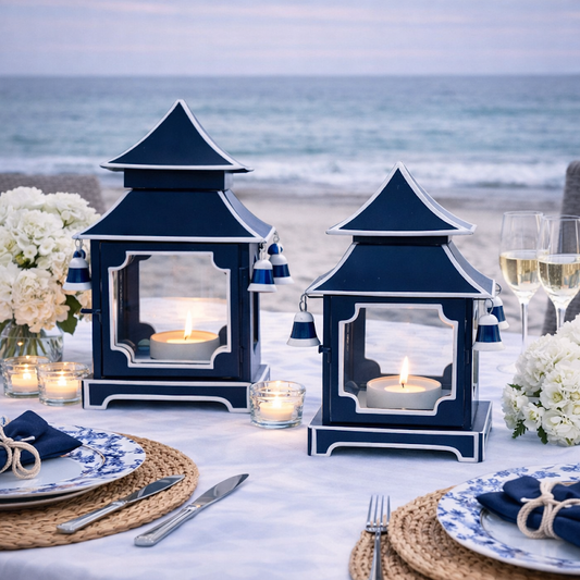 a table set with blue lanterns and flowers on it