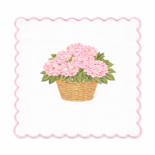 a basket of flowers on a white cloth