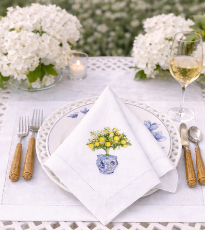 a table with a napkin and glasses of wine