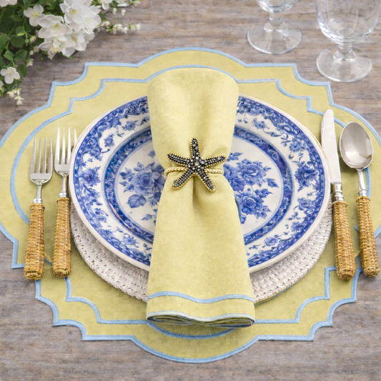 a plate with a napkin and silverware on a table