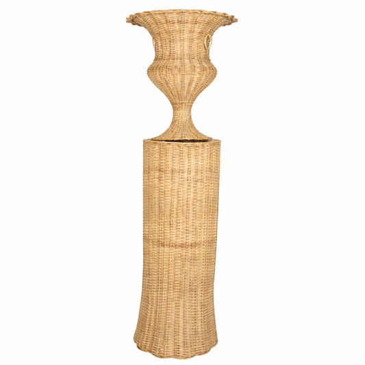 a tall wicker vase on a stand