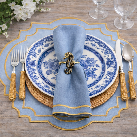 a plate with a napkin and silverware on a table