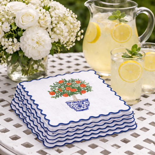 a stack of napkins and glasses of lemonade
