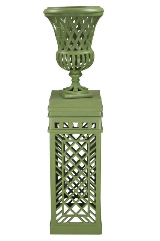 a green vase on top of a pedestal