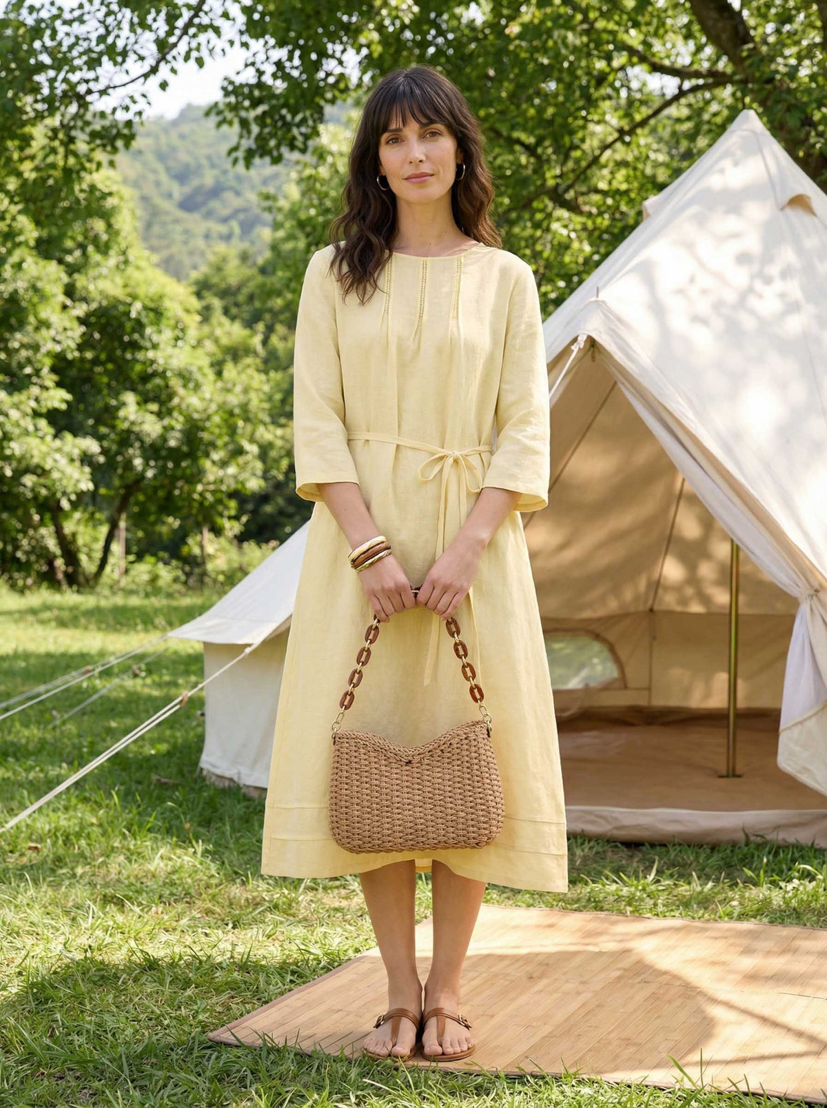 a woman in a yellow dress holding a purse