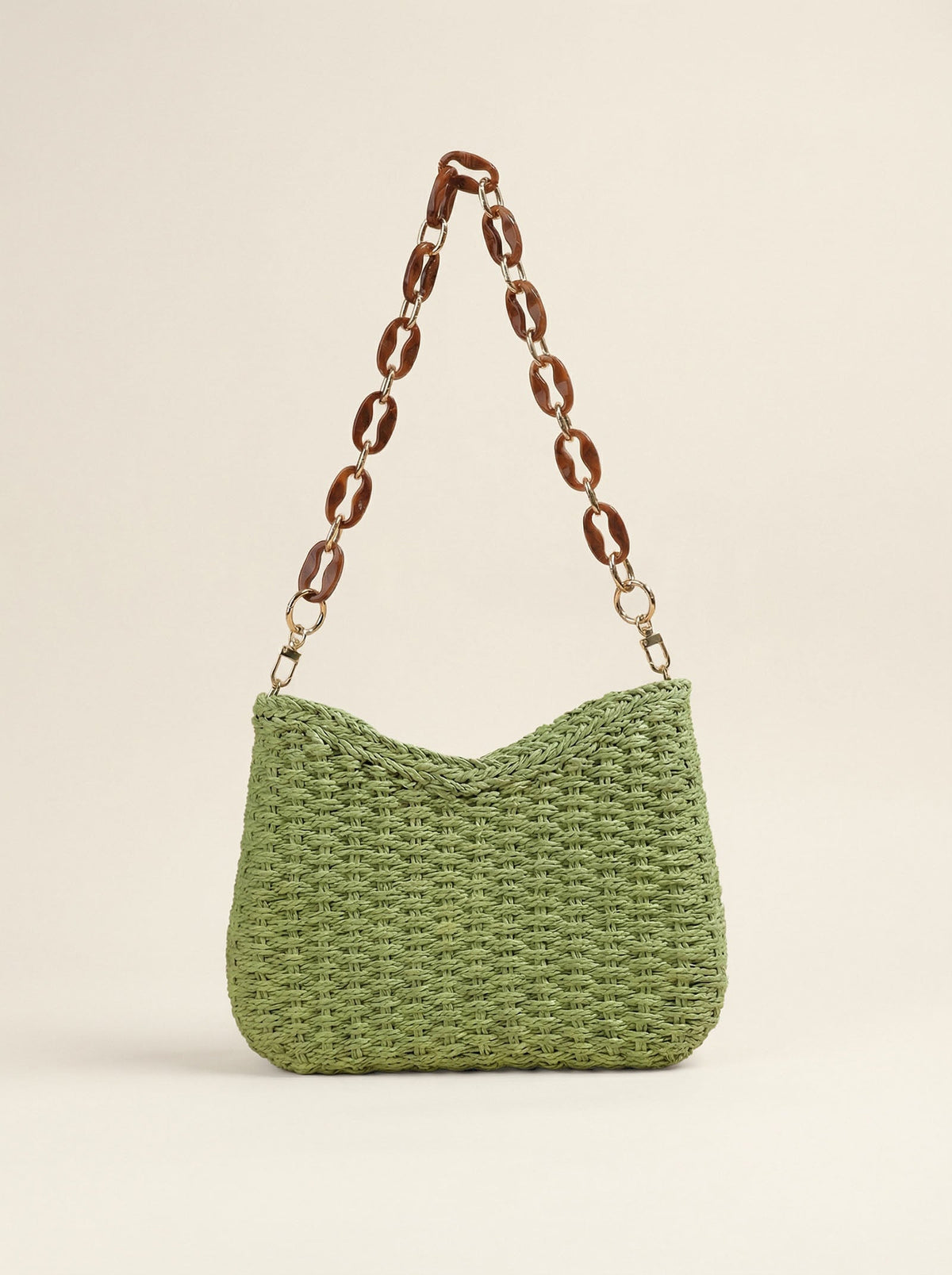 a green knitted bag with a brown chain