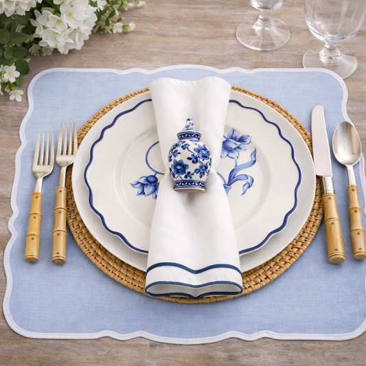 a plate with a napkin and silverware on a place mat