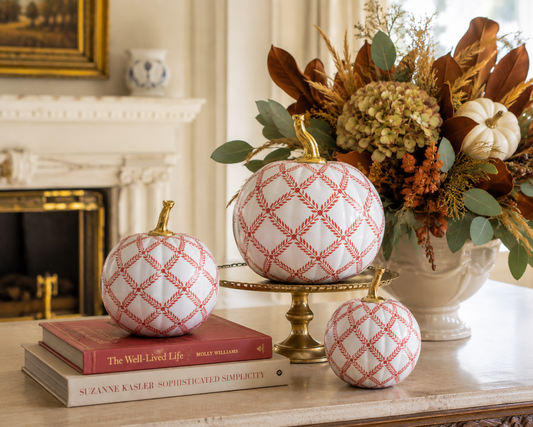 a group of white and red pumpkins on a table