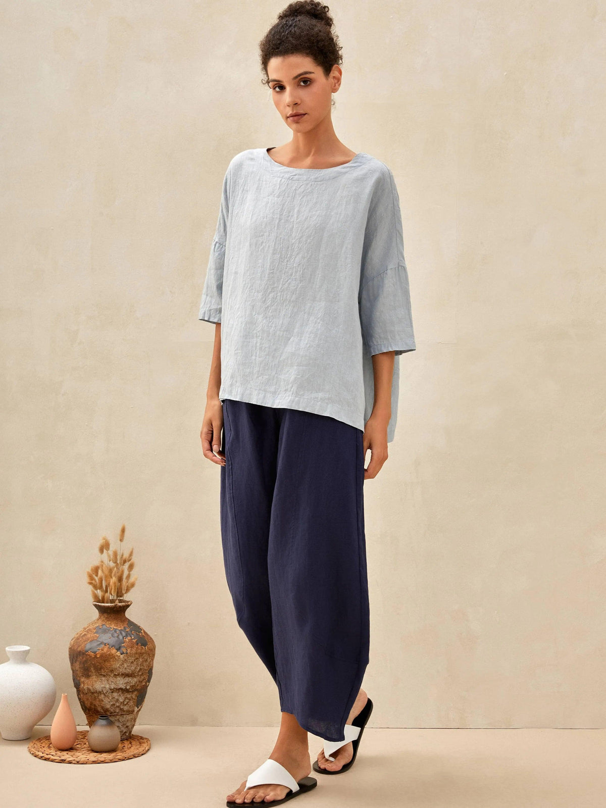a woman in a blue shirt and pants