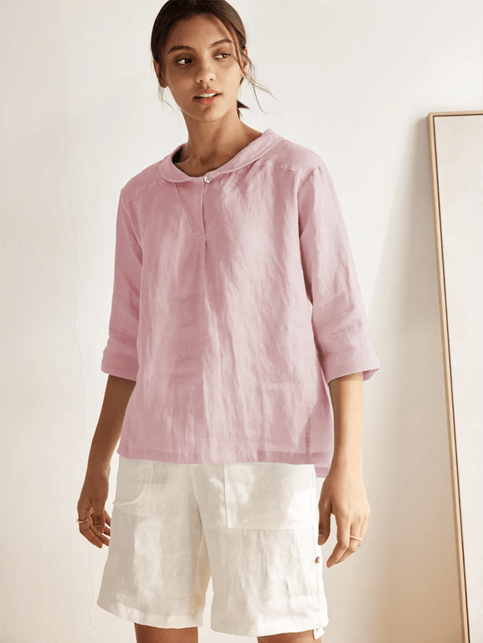 a woman wearing a pink shirt and white shorts