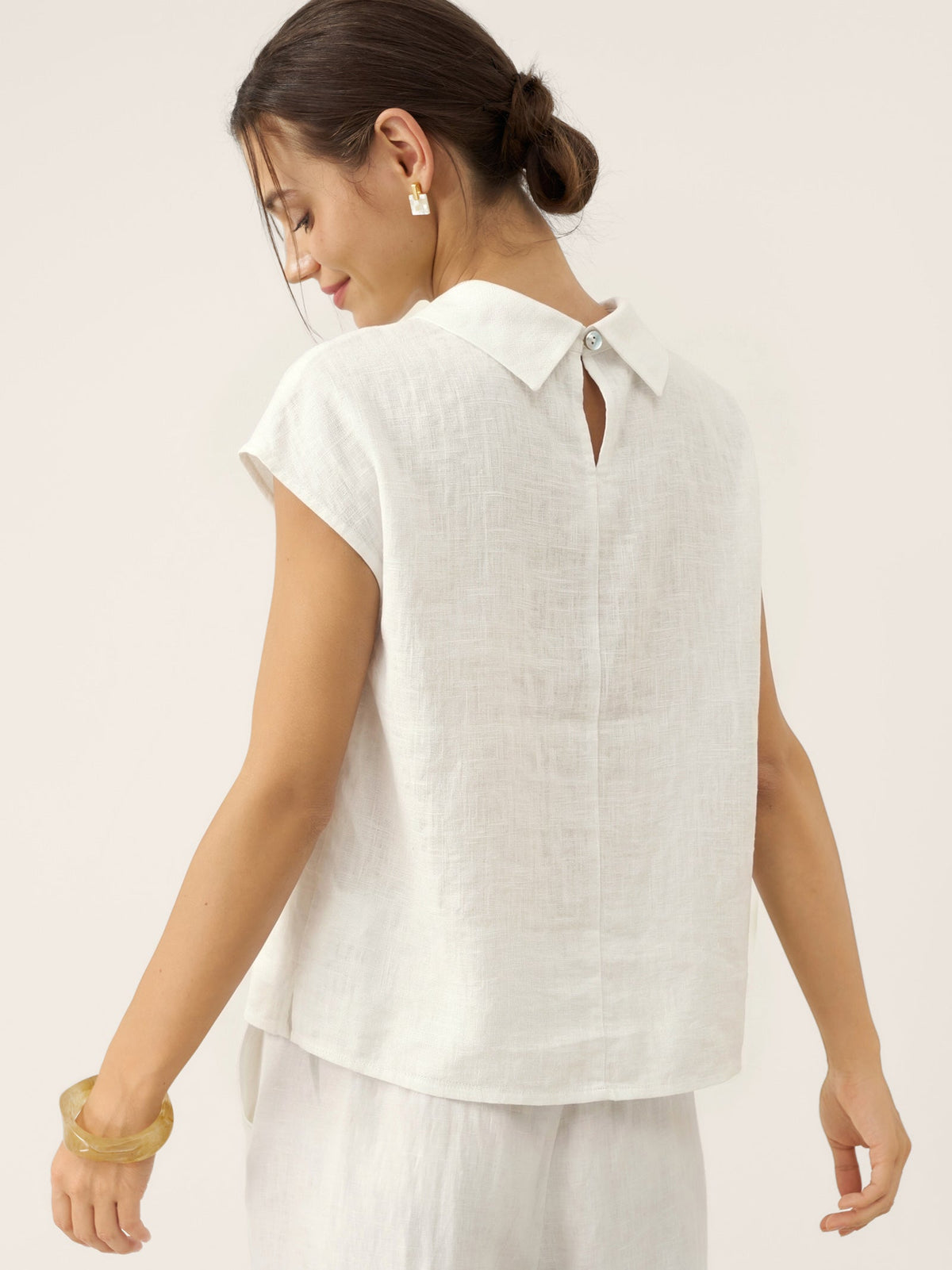 a woman in white shirt and white pants