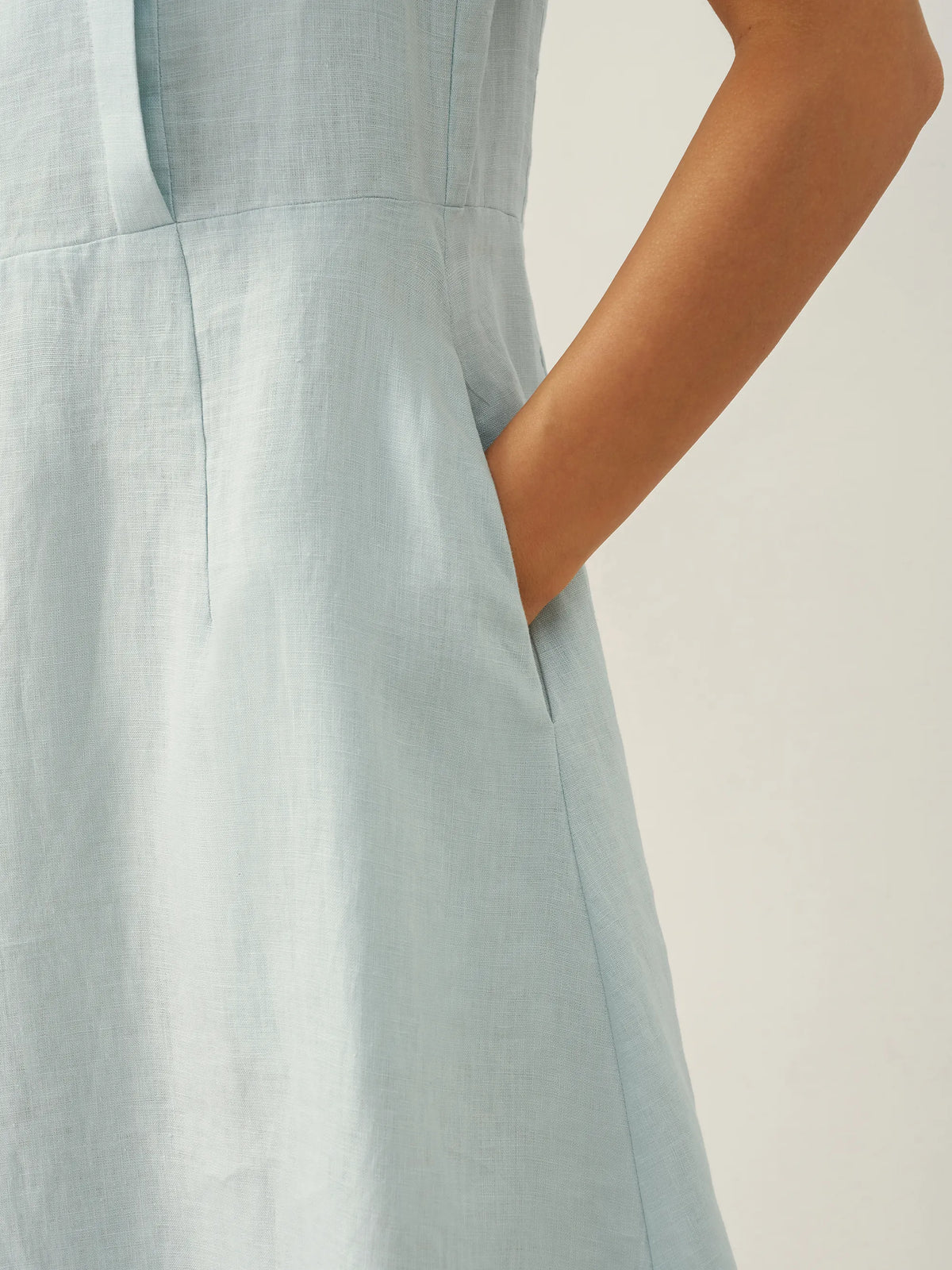 a close up of a woman's hand in a dress