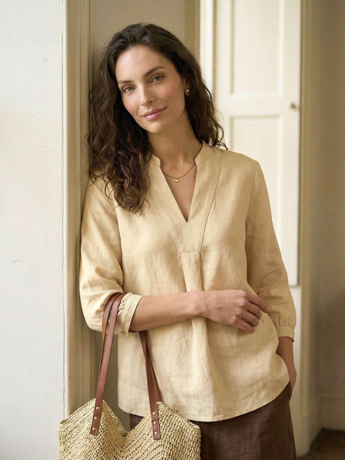 a woman leaning against a wall