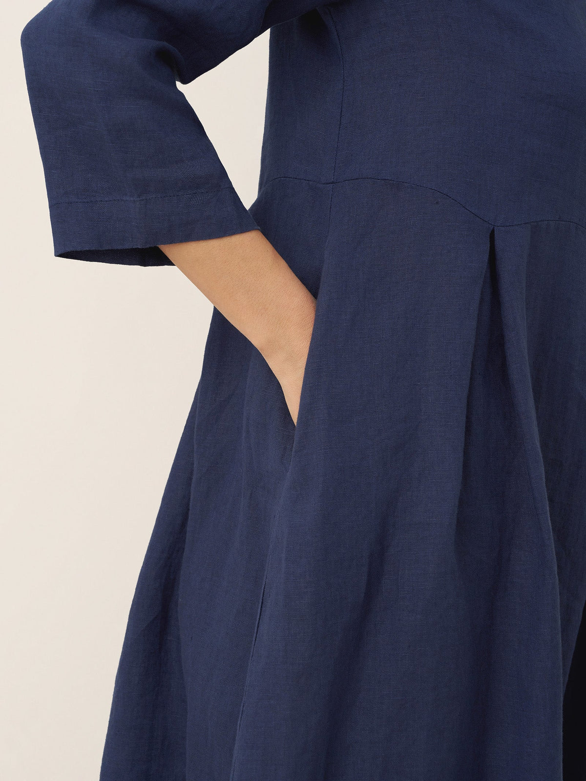 a close up of a woman's hand in a blue dress