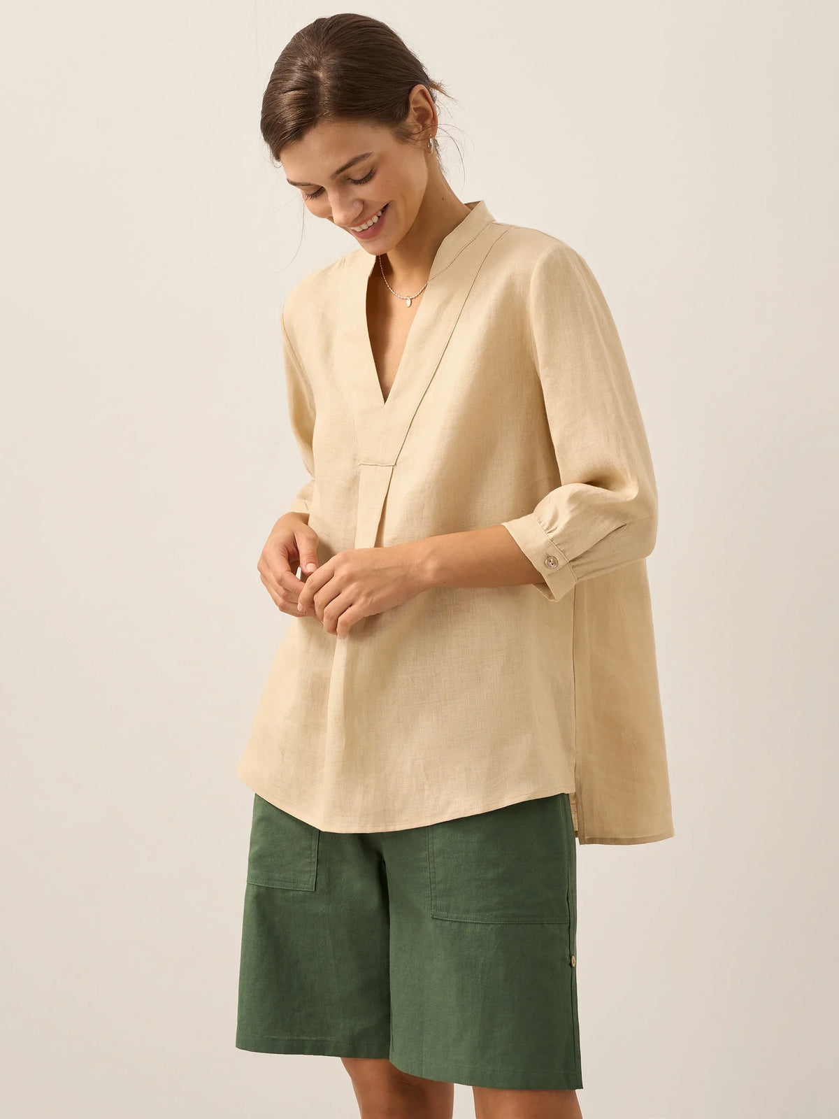 a woman smiling and looking down