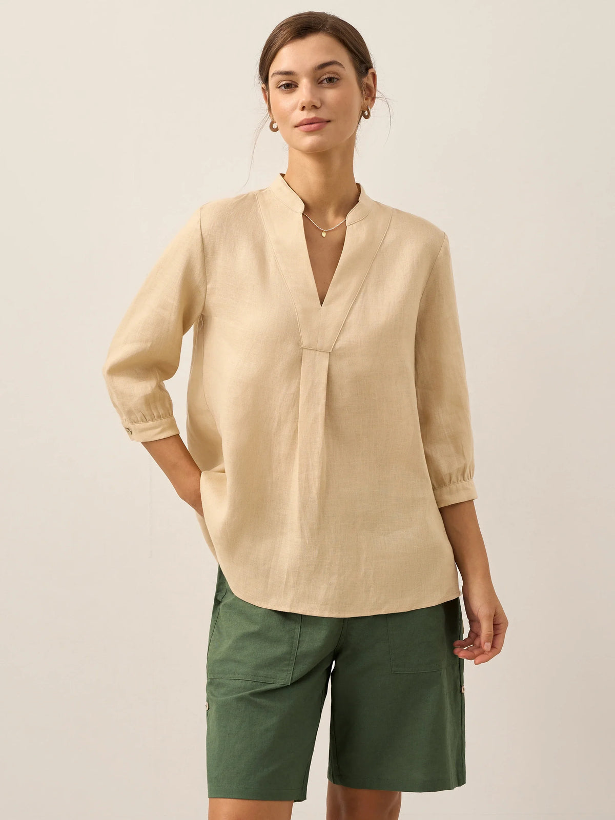 a woman in a beige shirt
