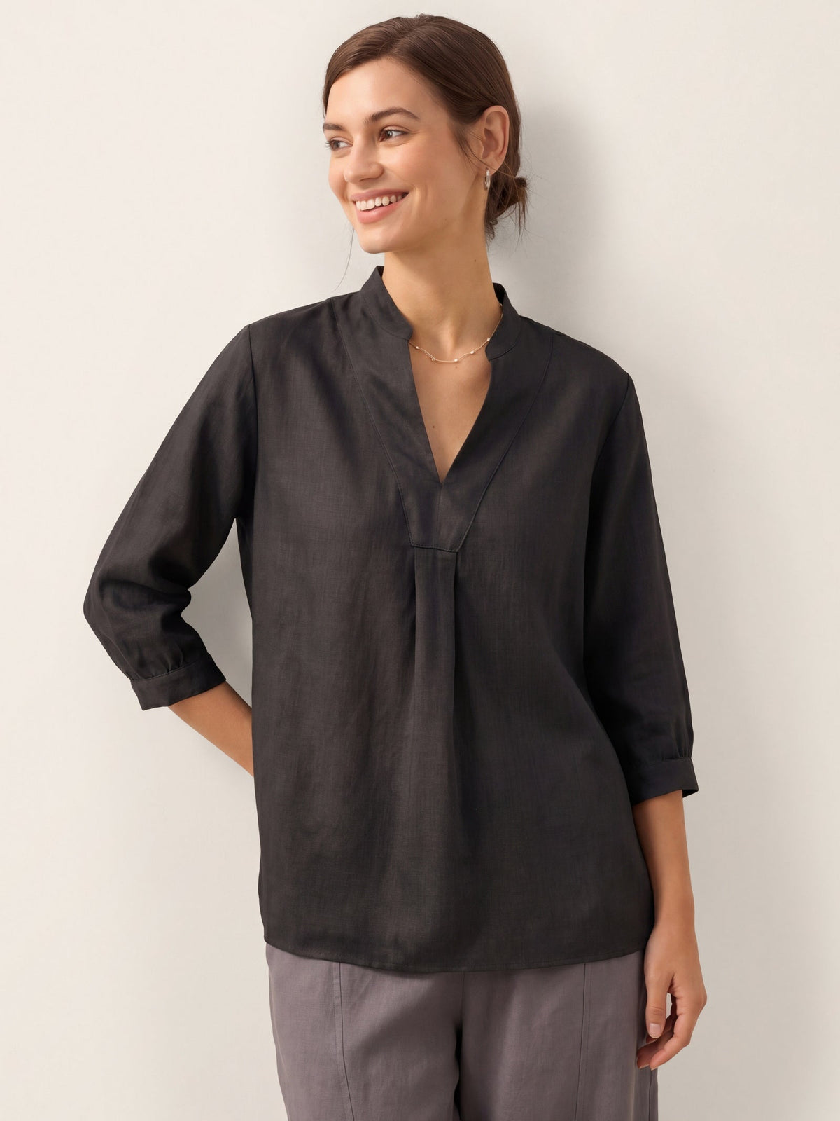 a woman smiling and looking away
